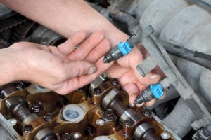 Person holding vehicle fuel injector