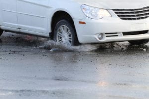 car driving through puddle of water 